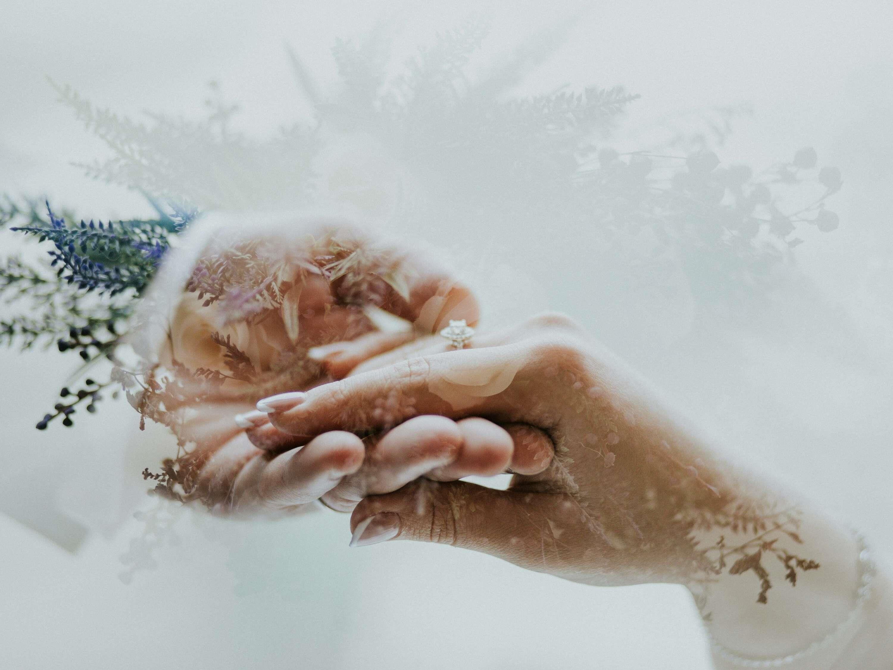 A close-up of hands holding a ring.