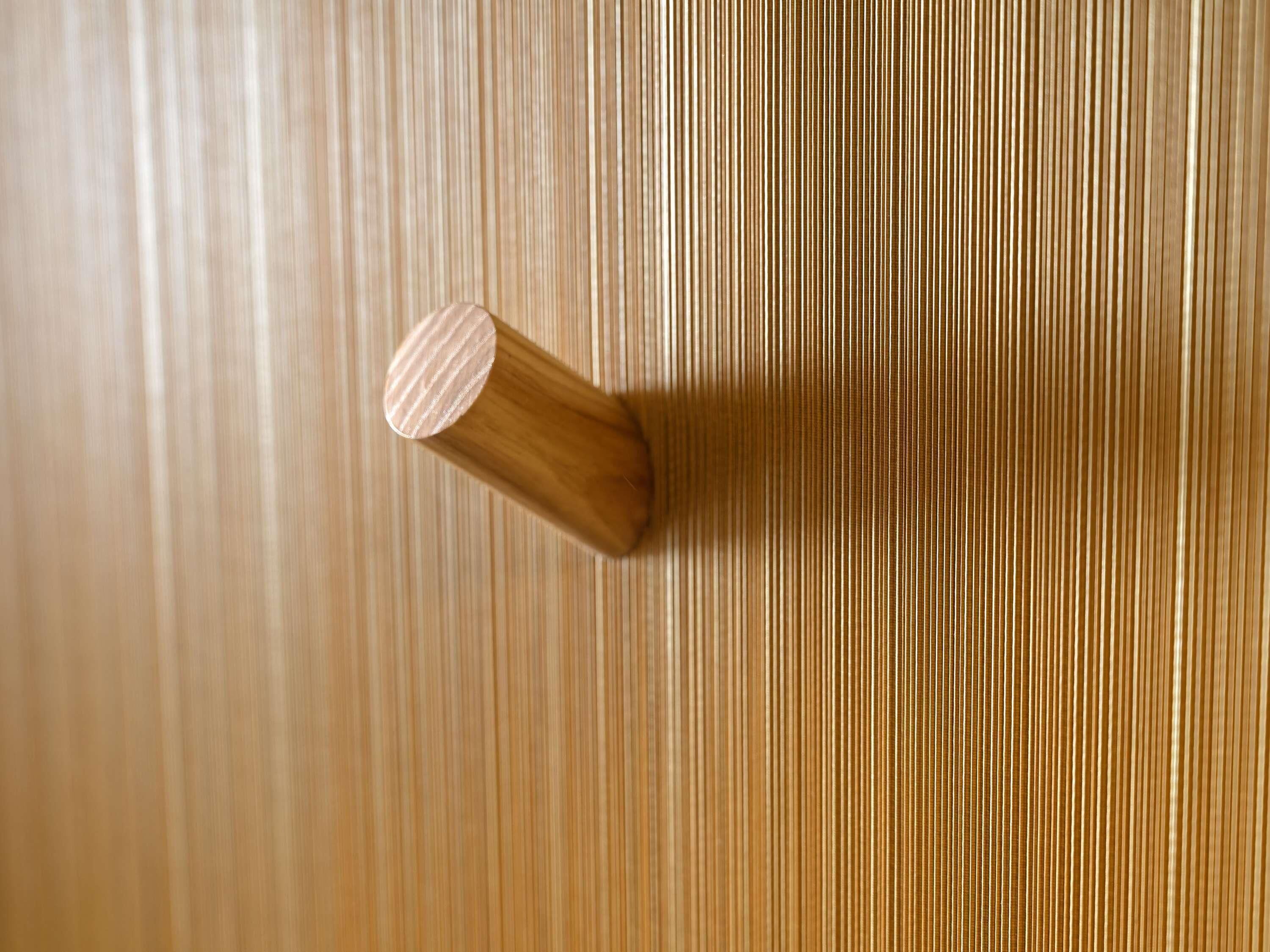 A wooden door with a vertical striped pattern.