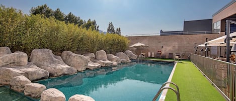 Seasonal outdoor pool, open 10:30 AM to 8:30 PM, pool umbrellas