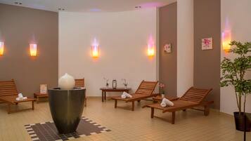 Relax in a serene spa area with lounge chairs, a central decorative piece, and ambient lighting.
