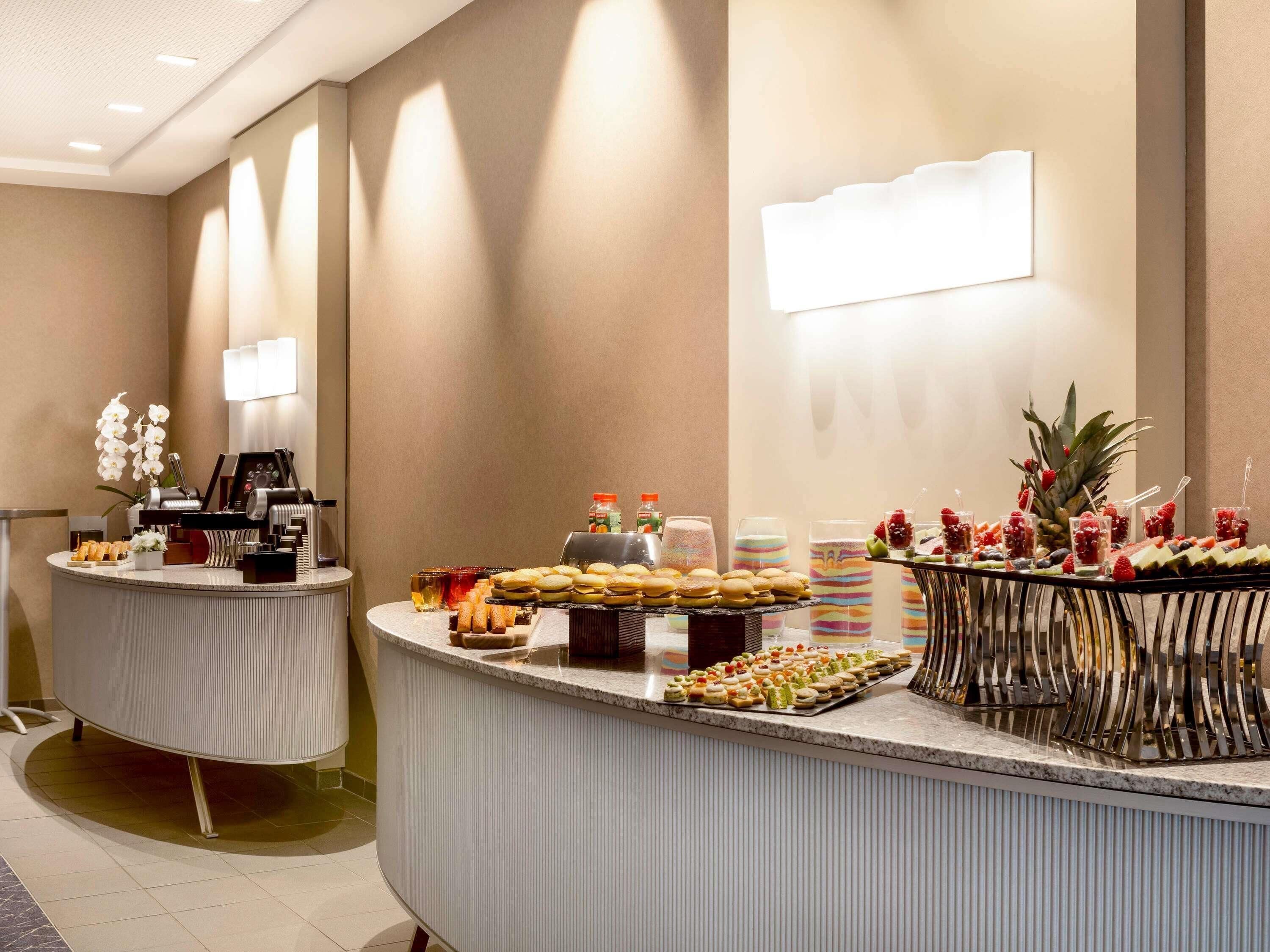 A buffet setup with various food items and a piano in the background.
