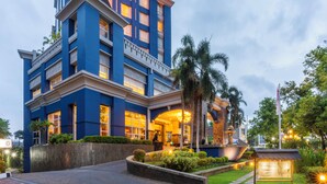 A modern hotel with a prominent 'Novotel' sign, featuring a multi-story structure with balconies and a well-lit entrance. - Novotel Semarang (Semarang)