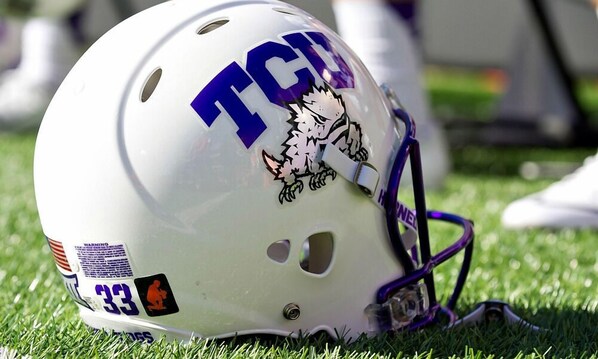 A white helmet with the letters "TGC" and a cartoon character, placed on grass. - Hyatt Place Fort Worth/Historic Stockyards (Fort Worth)