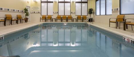 A pool area with chairs and a lifeguard station.