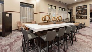 A conference room with a long table, multiple chairs, and decorative wall art. - Courtyard by Marriott Rochester Mayo Clinic Area/Saint Marys (Rochester)
