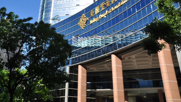 A tall, modern building with a curved facade and large glass windows. - Jinling Purple Mountain Hotel Shanghai (Shanghai)