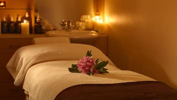 Experience tranquility in this serene spa room, featuring a well-appointed massage table and soothing ambiance.