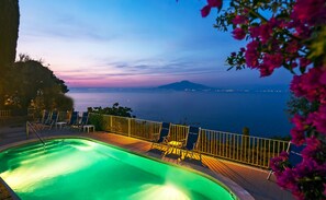 A swimming pool with a view of the sea and a mountain in the distance. - Hotel Miramare (Sorrento)