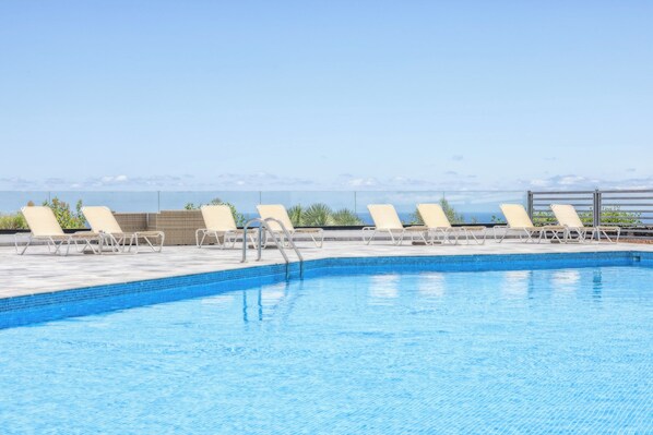 Outdoor pool, open 11:30 AM to 5:30 PM, pool umbrellas, pool loungers