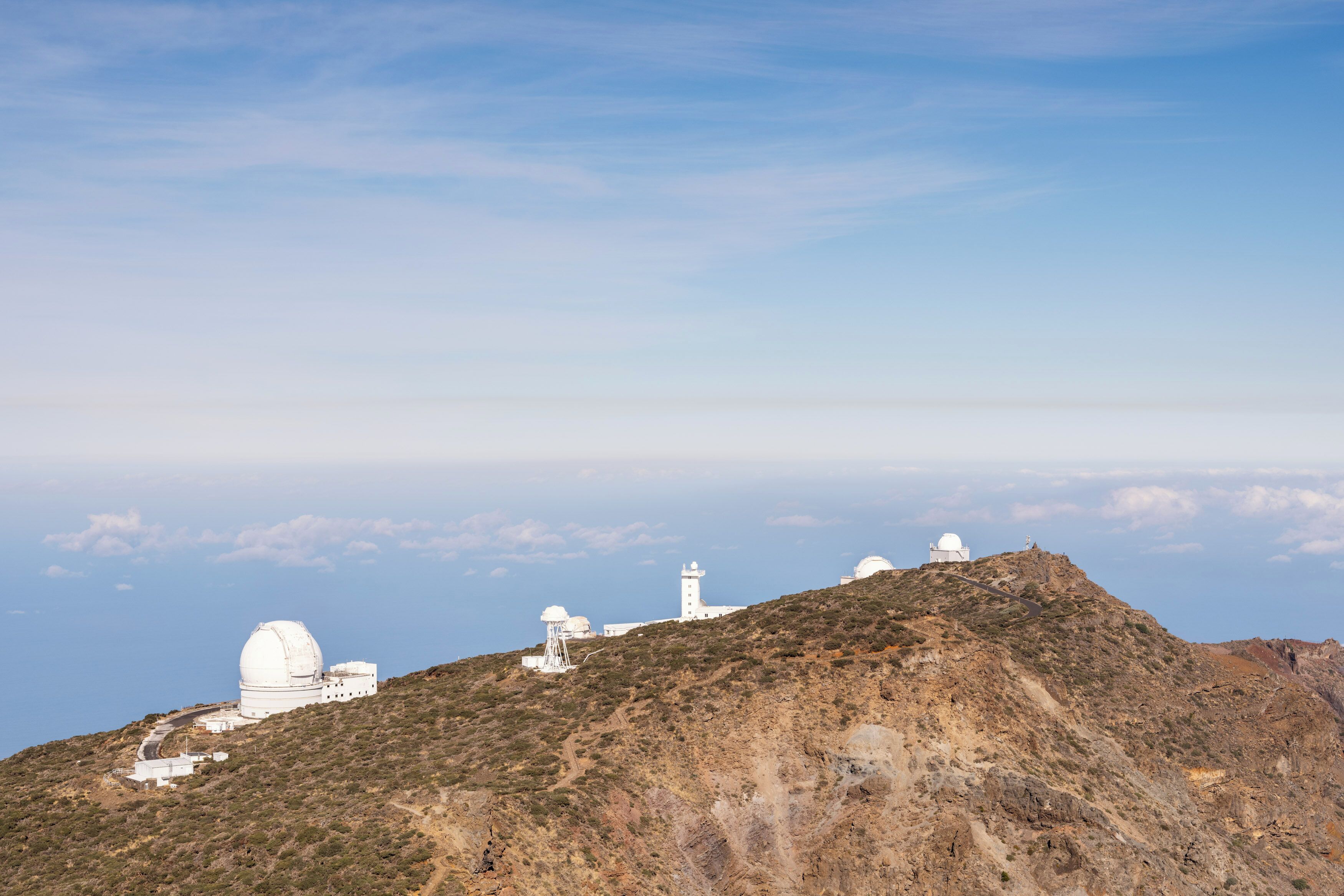 A mountainous landscape with white observatory buildings.