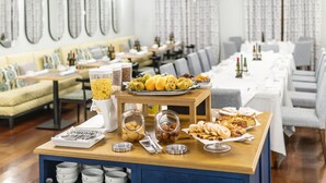 A buffet setup with various food items and condiments on a wooden table. - Parador de El Hierro (Valverde)