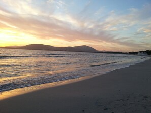 Gần bãi biển, cát trắng, dù trên bãi biển, khăn tắm biển 