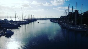 A marina with numerous sailboats docked along the water. - Hotel Mistral (Alghero)