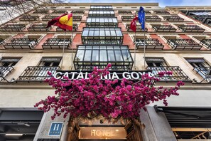 A hotel facade with balconies, a sign reading "CATALONIA GYM," and a flower display. - Catalonia Goya (Madrid)