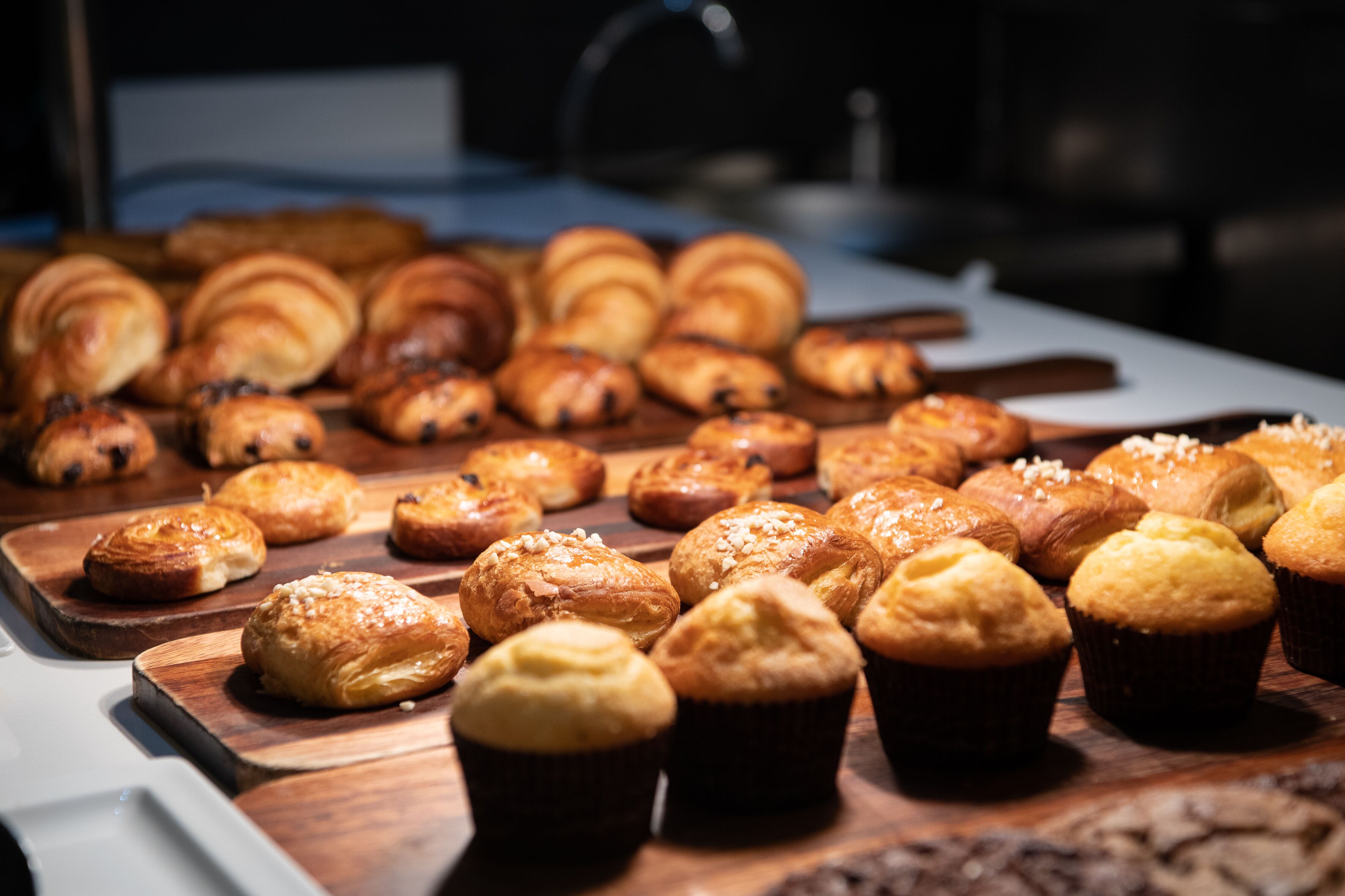 A variety of baked goods displayed on wooden boards.