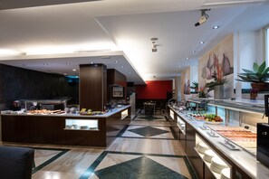 Eine moderne Hotelhalle mit einer Büfettinsel, einer Sitzecke und einem großen Gemälde an der Wand.