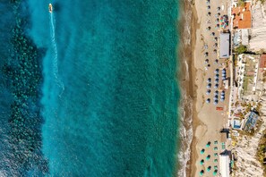 Private beach, black sand, sun loungers, beach umbrellas