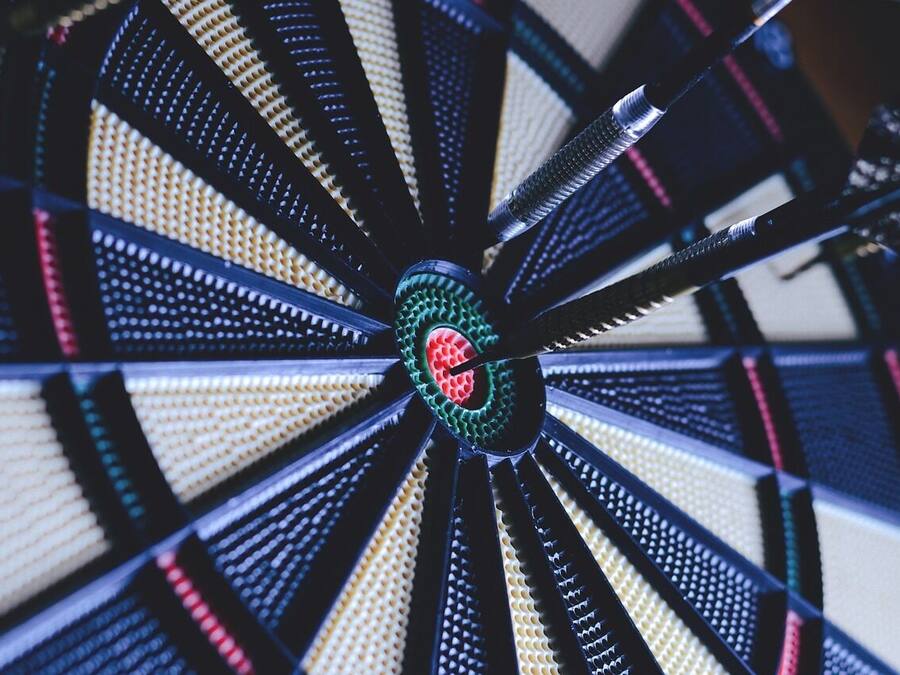 A dartboard with a central bullseye and multiple colored rings.