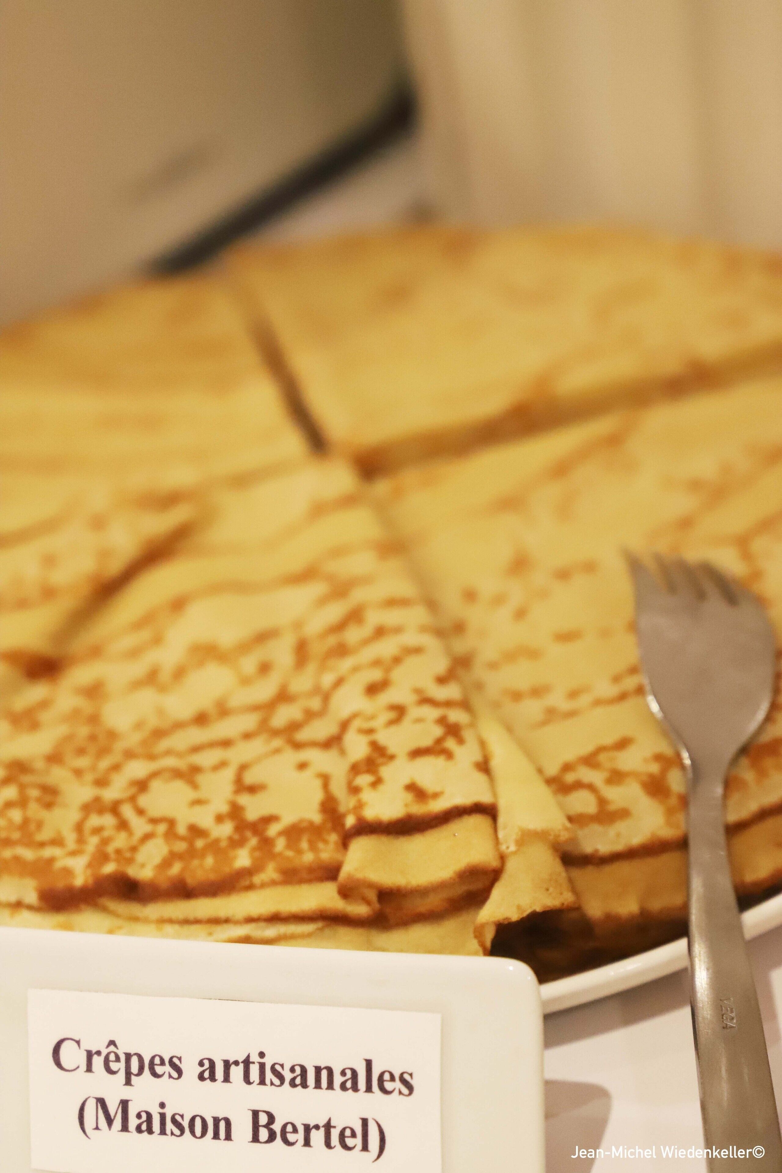 A plate of crepes with a fork on the side.