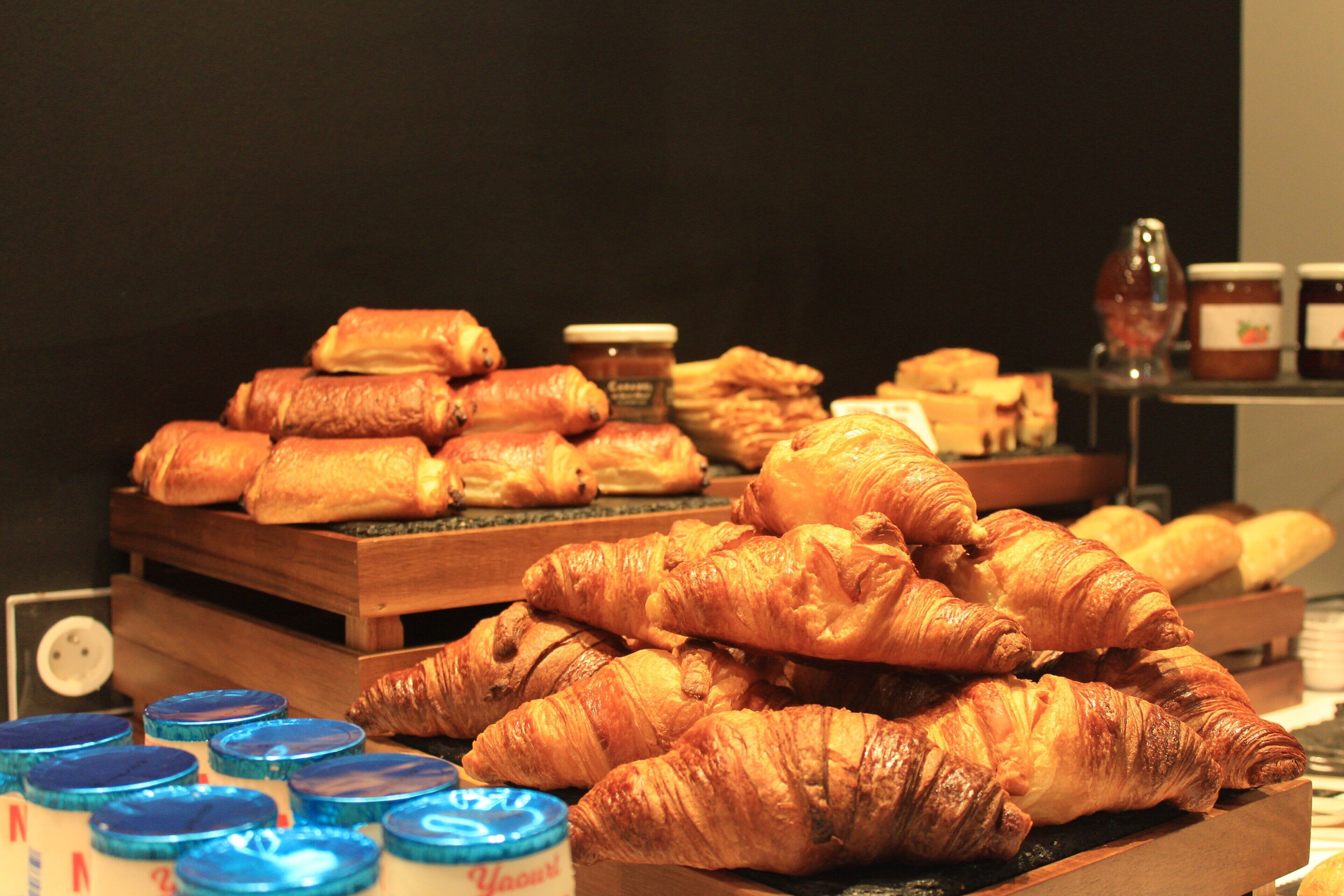 A display of pastries and jars of jam.