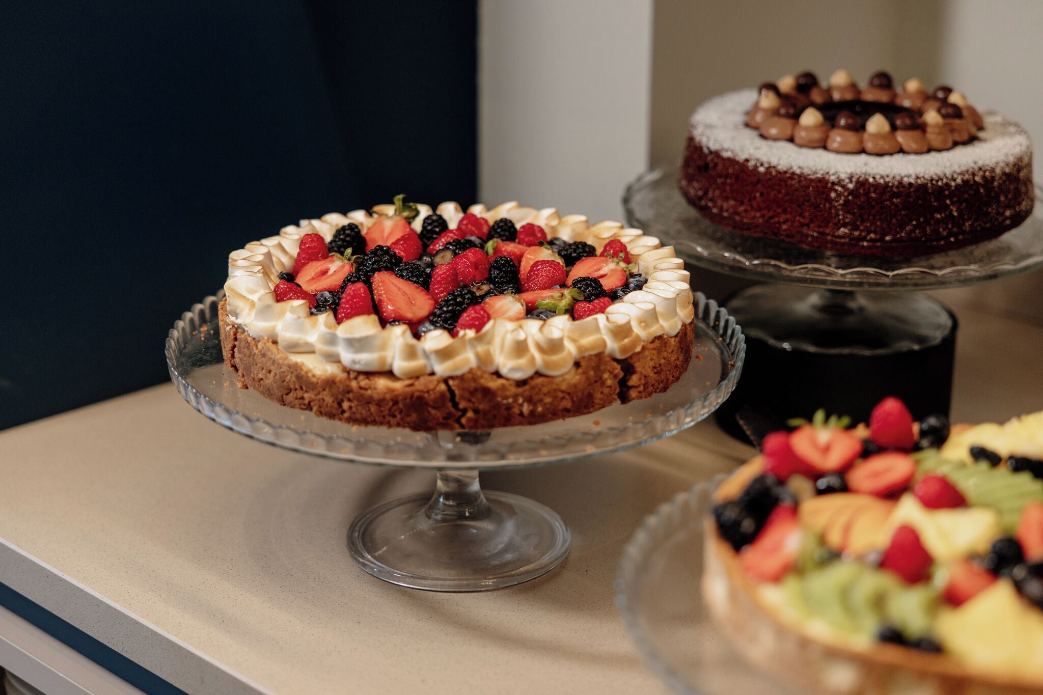 A dessert display with various cakes and pastries.