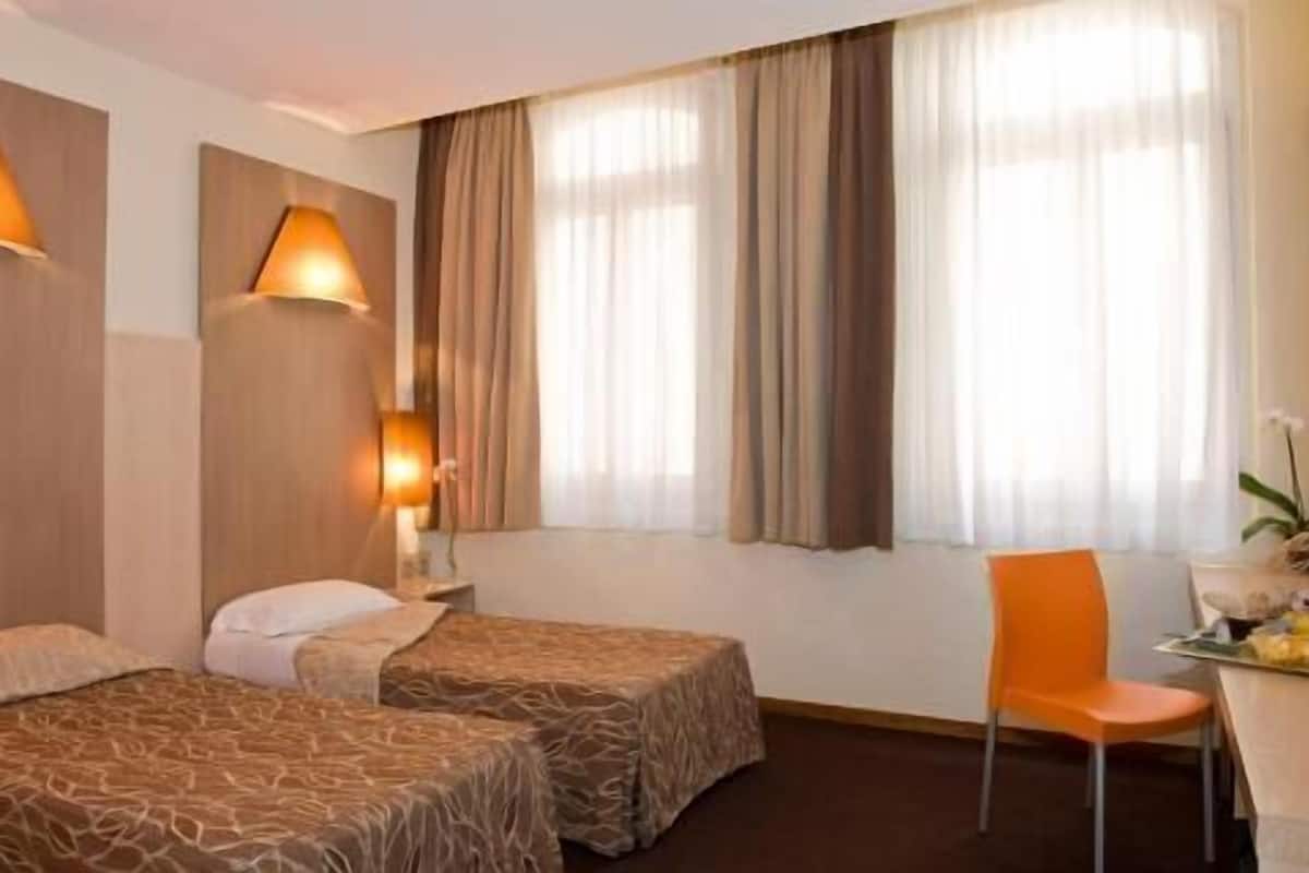 Premium bedding, desk, laptop workspace, blackout drapes