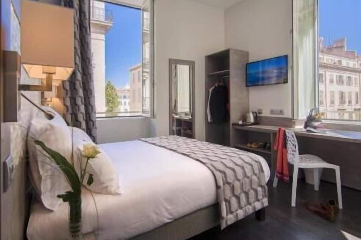 Premium bedding, desk, laptop workspace, blackout drapes