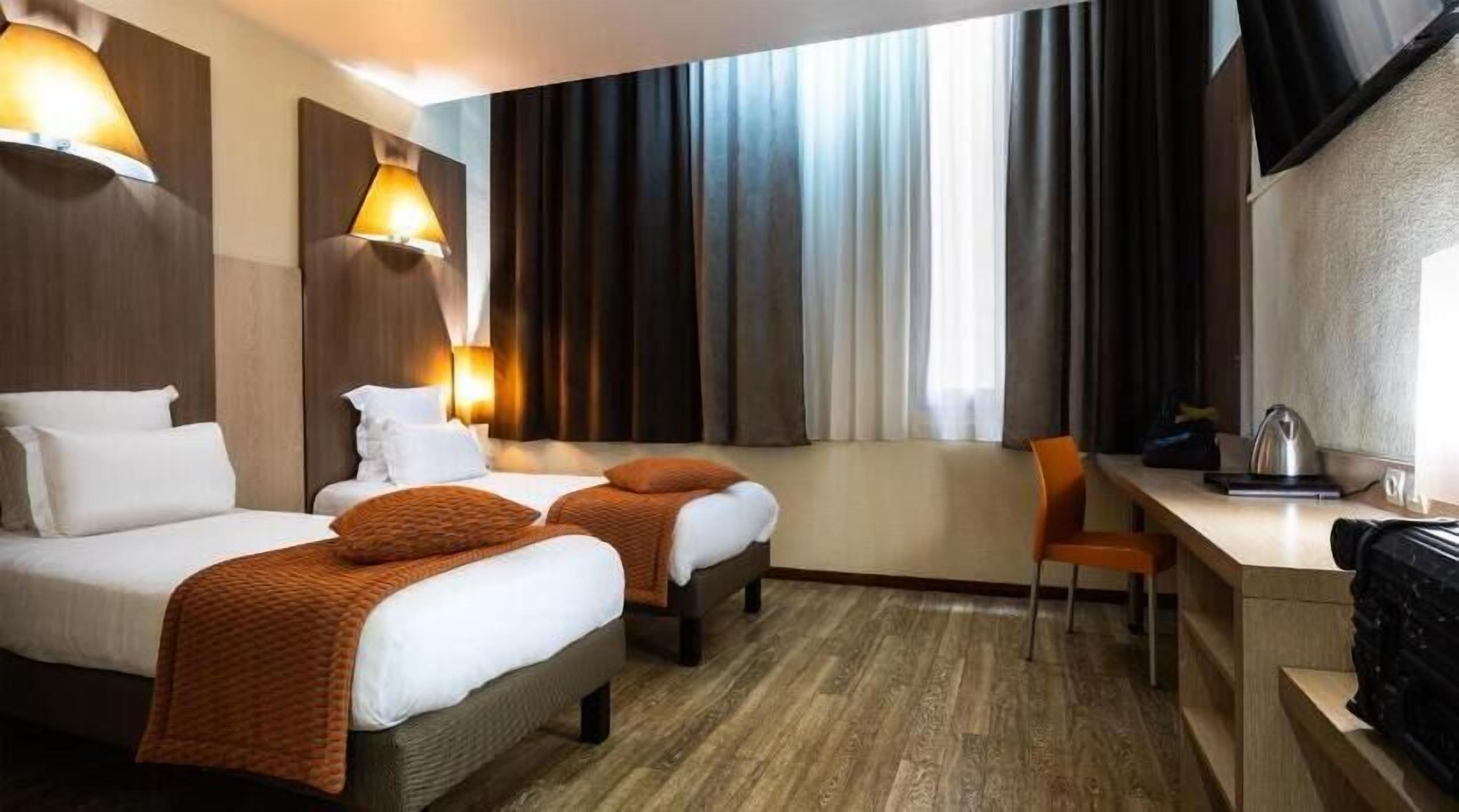 Premium bedding, desk, laptop workspace, blackout drapes