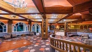 A spacious lobby with a high ceiling, ornate chandeliers, and a grand staircase. - Marhaba Beach (Sousse)