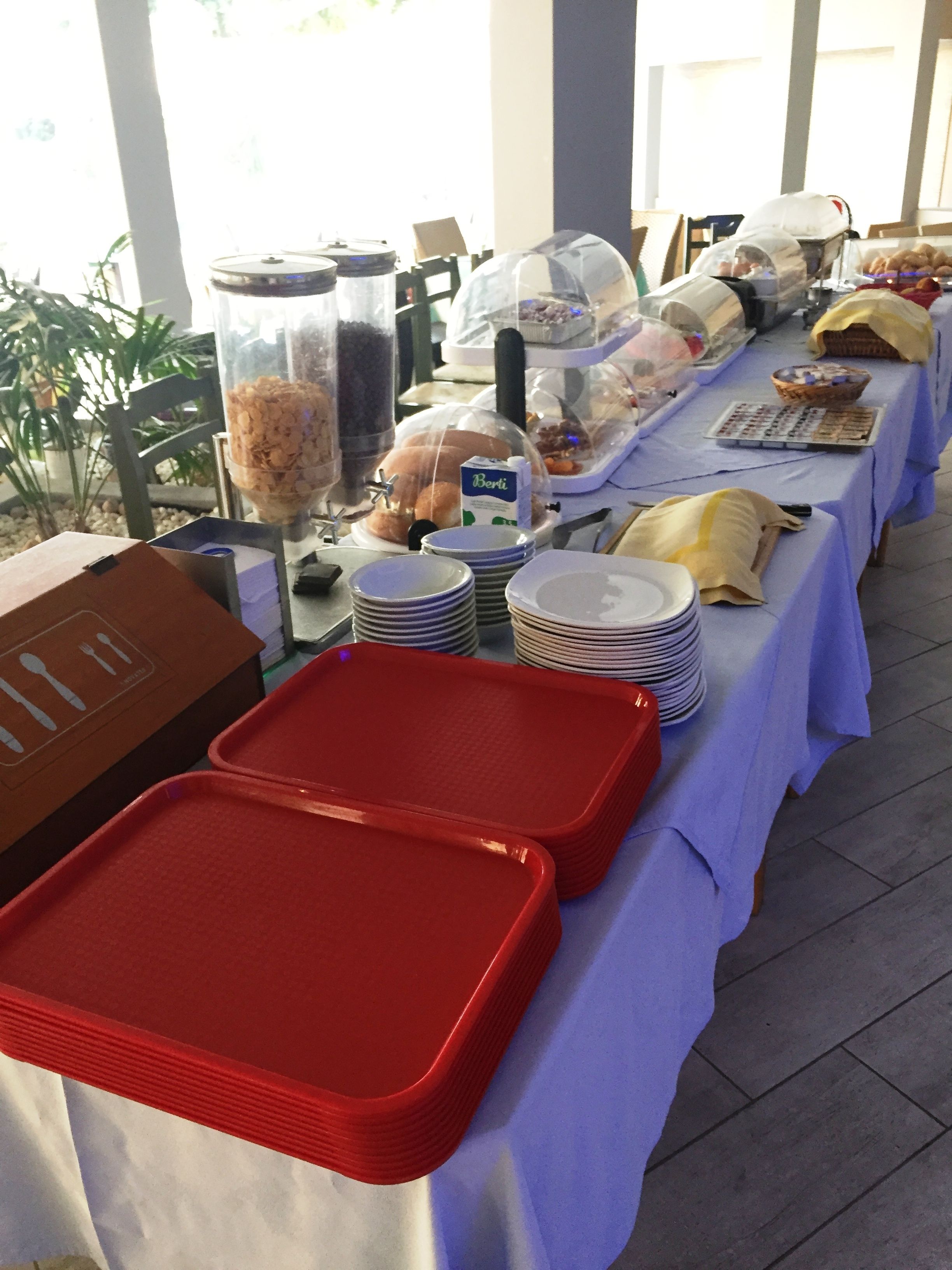 A buffet table with various food items and serving dishes.