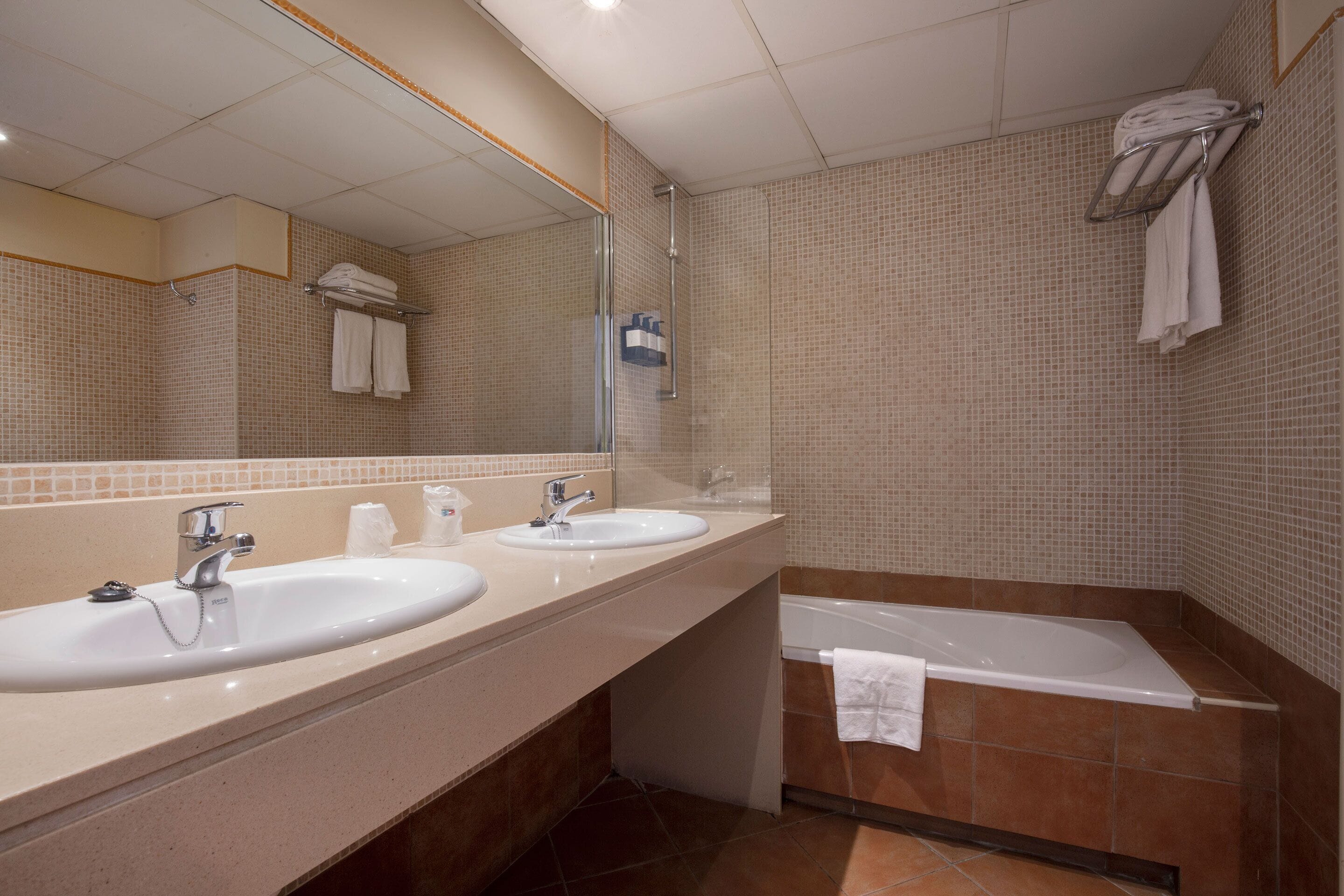 deep-soaking bathtub, designer toiletries, hair dryer, towels