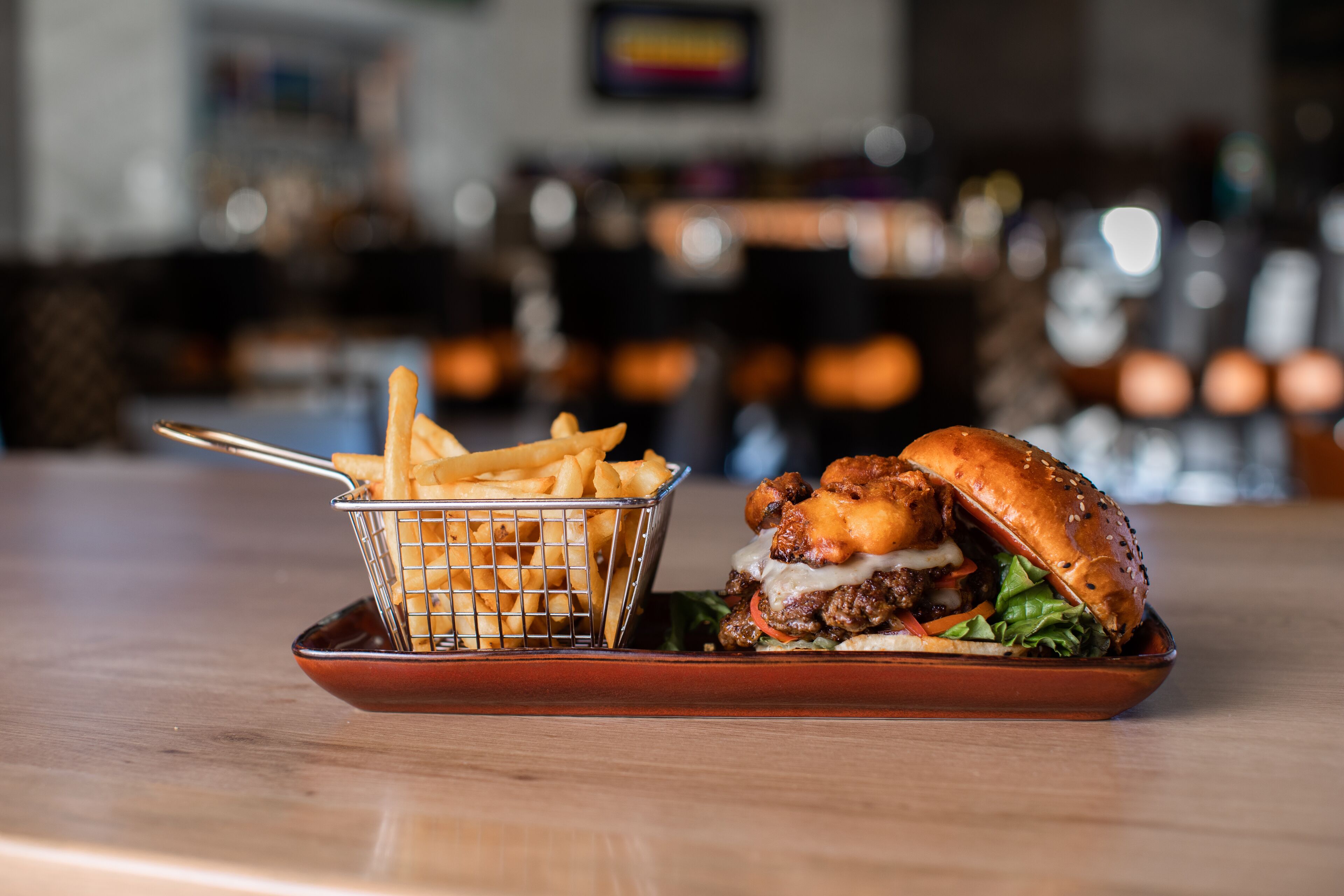 A burger and fries on a tray.