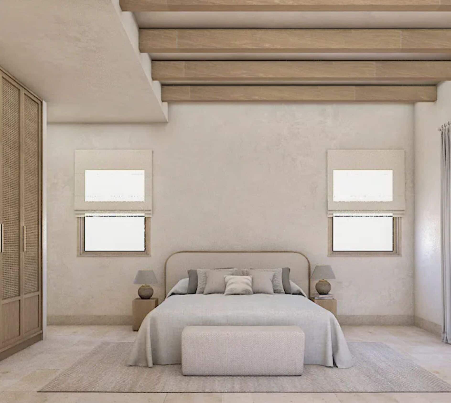 A modern bedroom with a bed centered under a sloped ceiling, flanked by two bedside tables with lamps, a large window on one side, and a door with a textured panel.