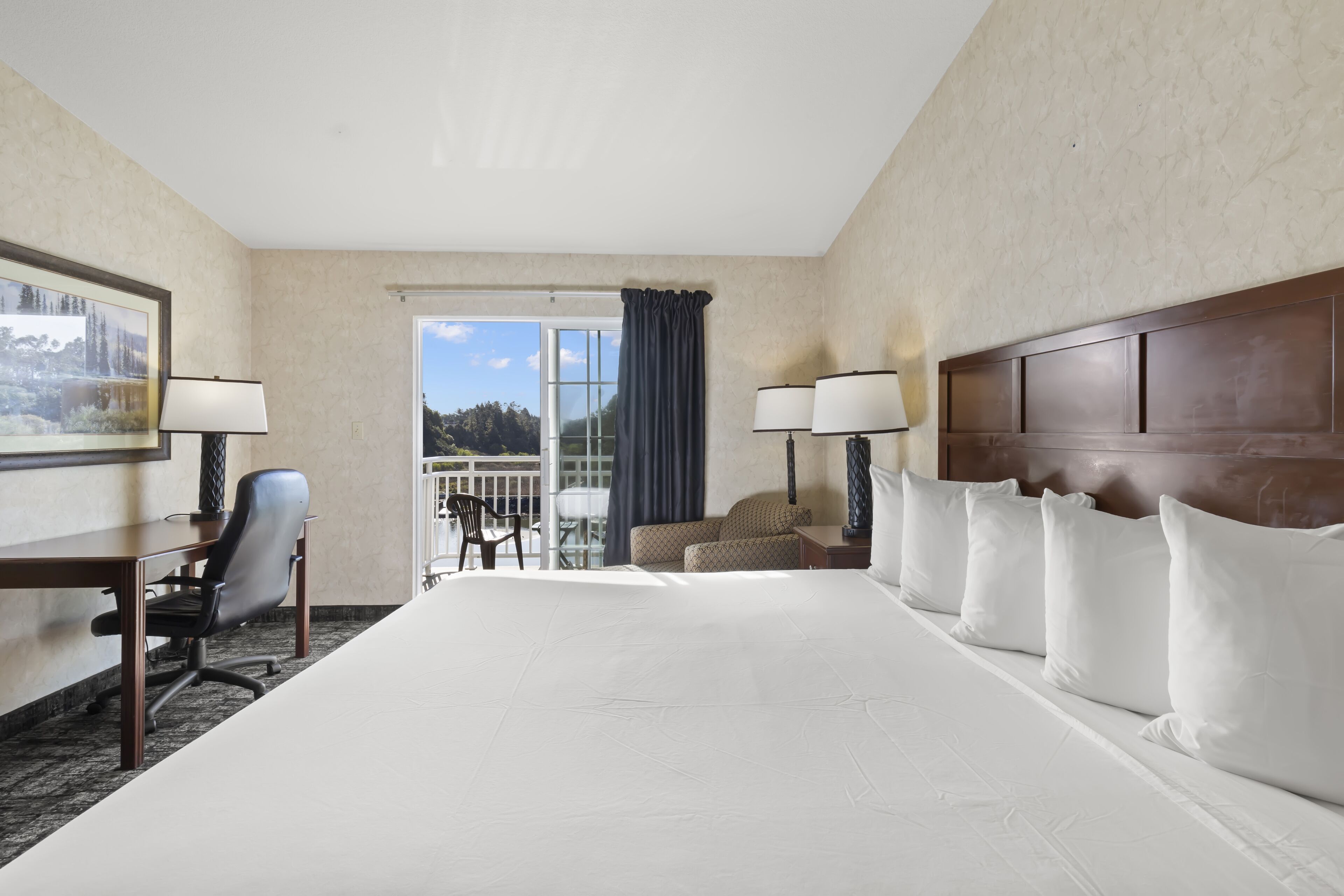 king bed with soaking tub | hypo-allergenic bedding, desk, laptop workspace, blackout curtains