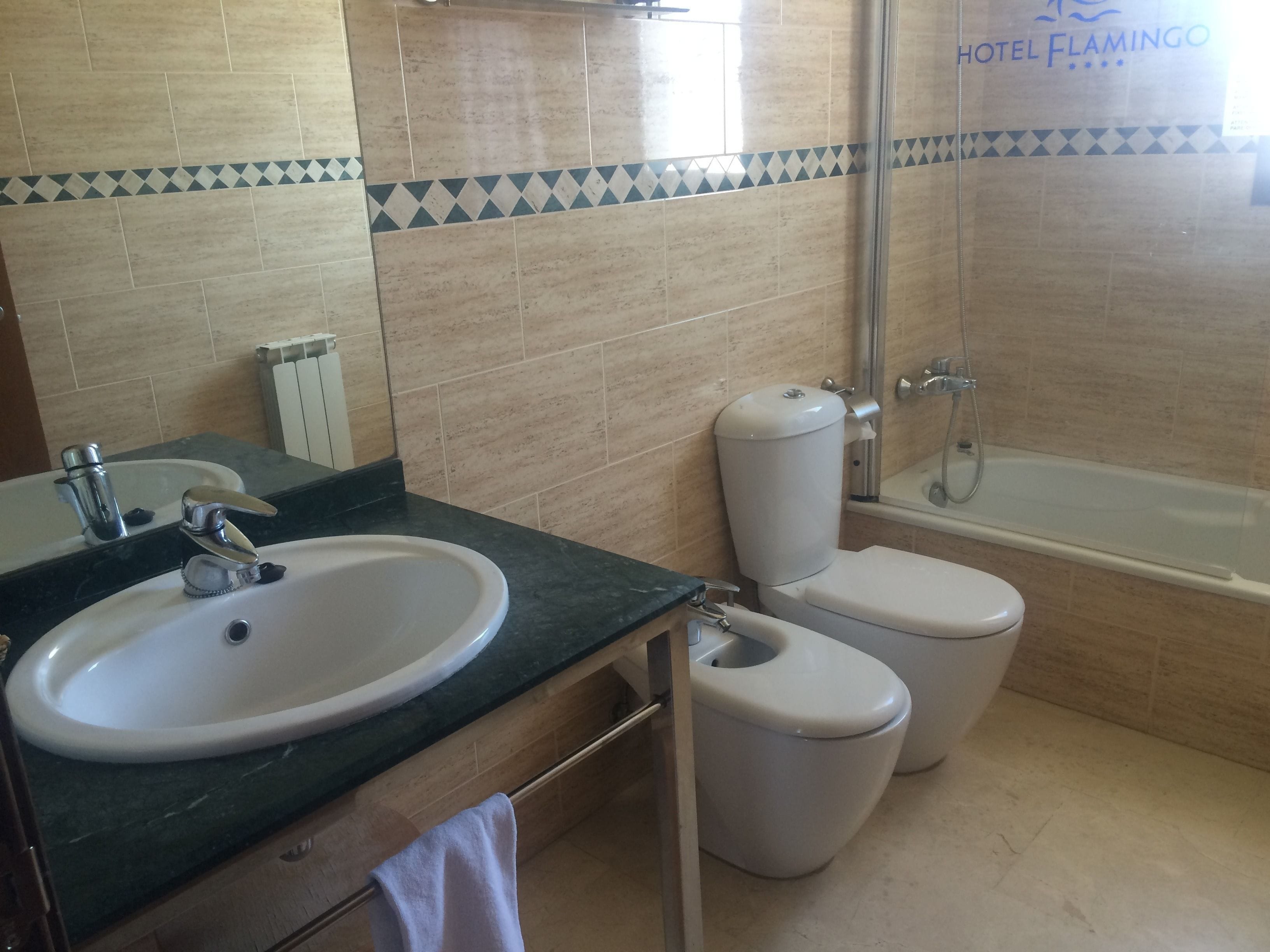 A bathroom with a sink, toilet, and shower.
