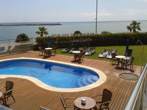 Outdoor pool, open 9:00 AM to 9:00 PM, pool umbrellas, pool loungers