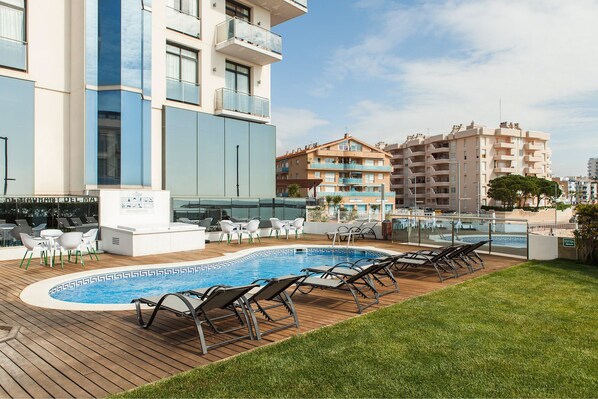 Outdoor pool, open 9:00 AM to 9:00 PM, pool umbrellas, pool loungers