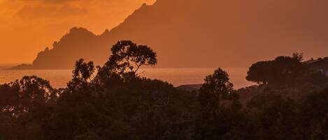 A mountainous landscape with a sunset.