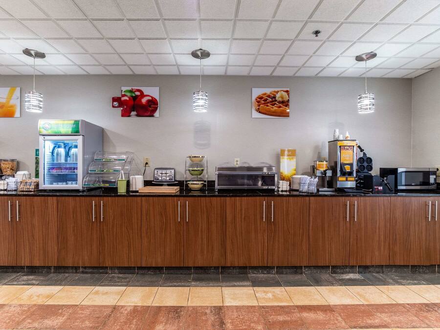 Una colazione con frigorifero, macchina del caffè, microonde e diversi alimenti.