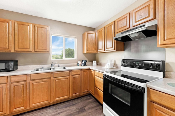 Suite, 2 Queen Beds, Non-Smoking | Desk, blackout drapes, iron/ironing board, free cribs/infant beds