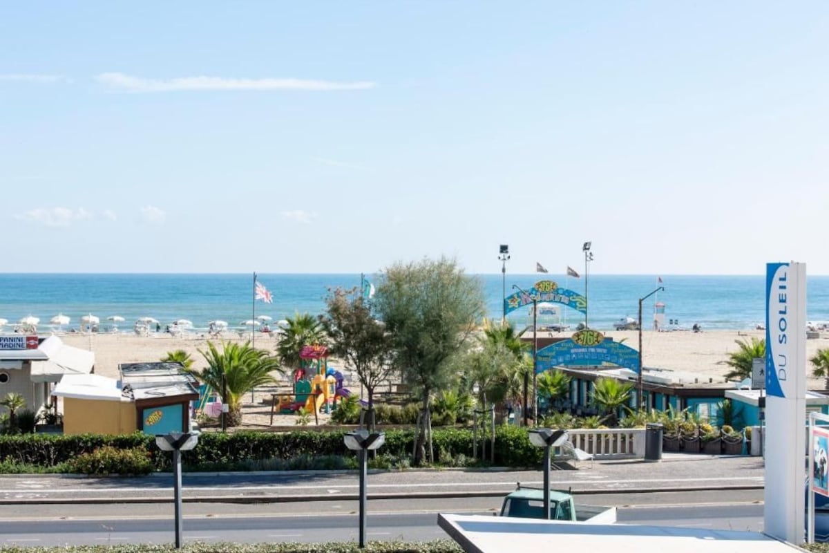 A beachside view with a sign for 'Du Soleil' and a playground area.