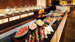 A buffet with various food stations, including a sushi bar and a selection of appetizers. - Hotel Nikko Nara (Nara)