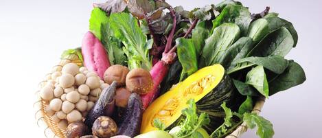 A basket filled with various vegetables and fruits.