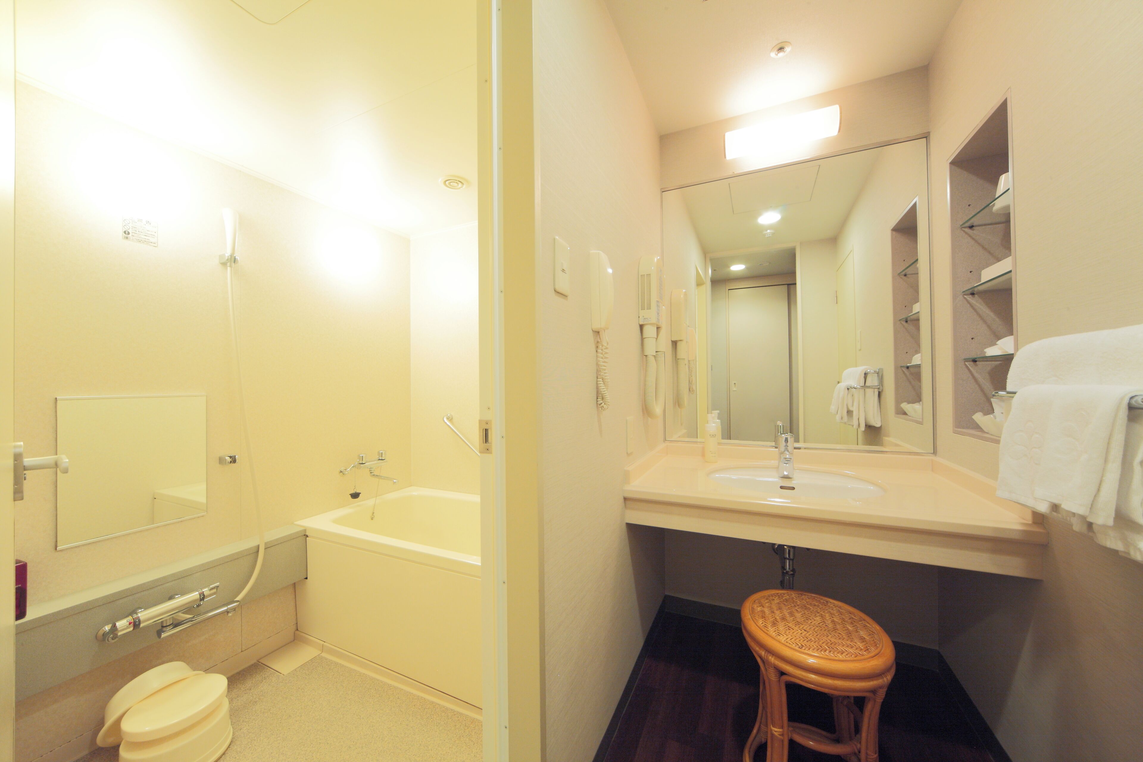 A bathroom with a bathtub, toilet, sink, and a mirror.