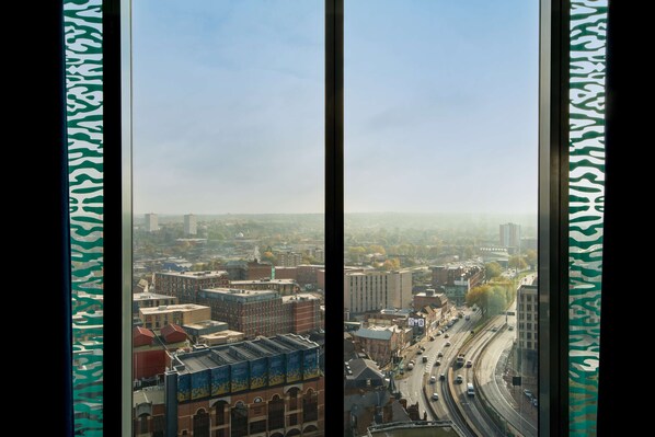 A cityscape view from a high-rise building with a clear sky.