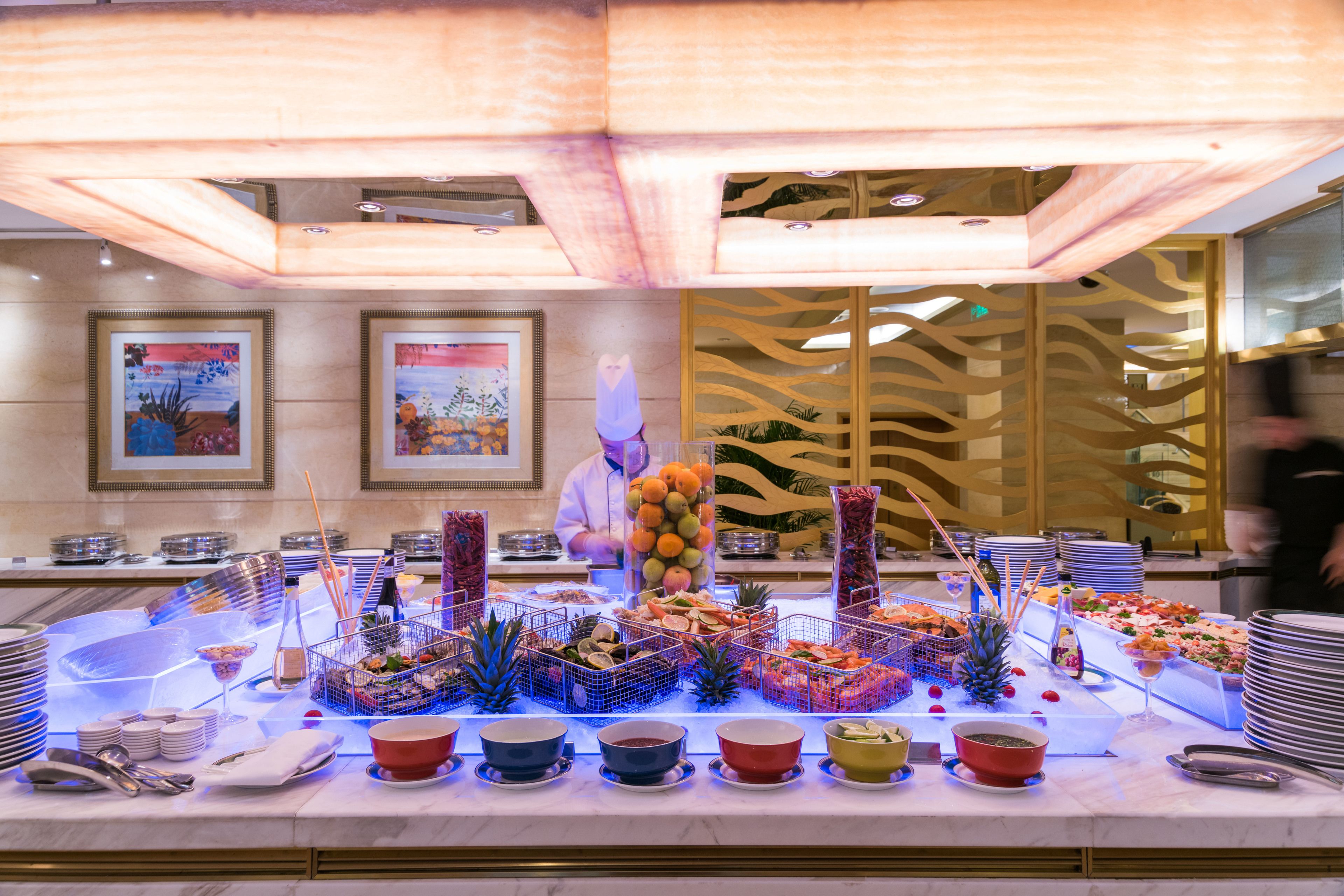 A buffet setup with various food items and drinks.