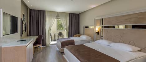 A hotel room with two beds, a desk, a chair, a TV, and a balcony with a table and chairs.