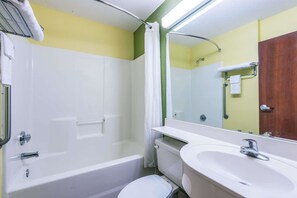 A bathroom with a bathtub, toilet, and sink.