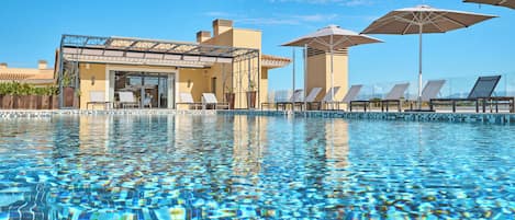 Indoor pool, outdoor pool, pool umbrellas, sun loungers