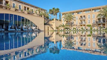 Indoor pool, outdoor pool, pool umbrellas, pool loungers